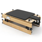 Foldable Pilates Reformer Flexi, light wood, black upholstery – folded