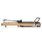 Foldable Pilates Reformer Flexi, light wood, black upholstery – side view