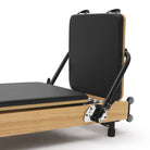 Foldable Pilates Reformer Flexi, light wood, black upholstery – jumpboard