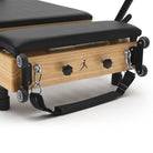 Foldable Pilates Reformer Flexi, light wood, black upholstery – handles and wheels
