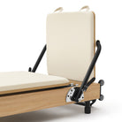 Foldable Pilates Reformer Flexi, light wood, milky white upholstery – jumpboard