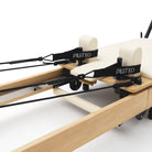 Foldable Pilates Reformer Flexi, light wood, milky white upholstery – carriage with shoulder rests