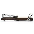 Foldable Pilates Reformer Flexi, dark wood, milky white upholstery – side view