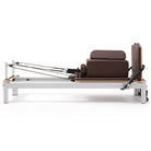 Pilates reformer aluminum mocha, side view with sitting box
