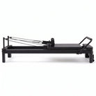 Pilates reformer aluminum total black, side view, footbar raised