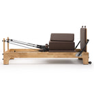 Pilates reformer Classic mocha, side view with sitting box