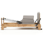 Pilates reformer Classic pearl grey, side view with sitting box